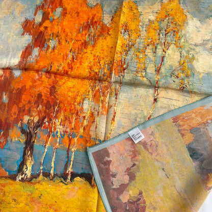 The Autumn Painting scarf with a corner folded back to show the reverse print, edge and fabric label