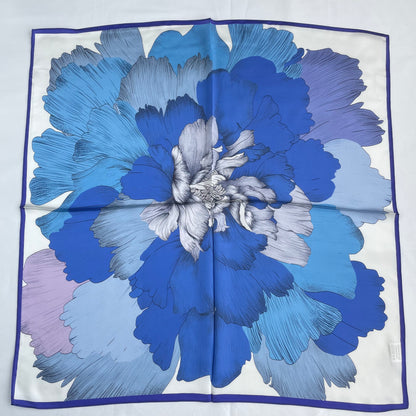 The Blue Flowers scarf laid flat, showing a large blue flower inside a narrow blue border