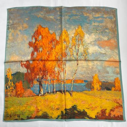 The Autumn Painting scarf laid flat, showing orange and yellow trees beside blue water