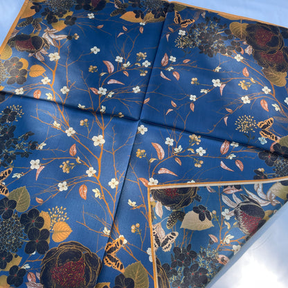 The Garden scarf with a corner turned back, revealing its reverse floral print