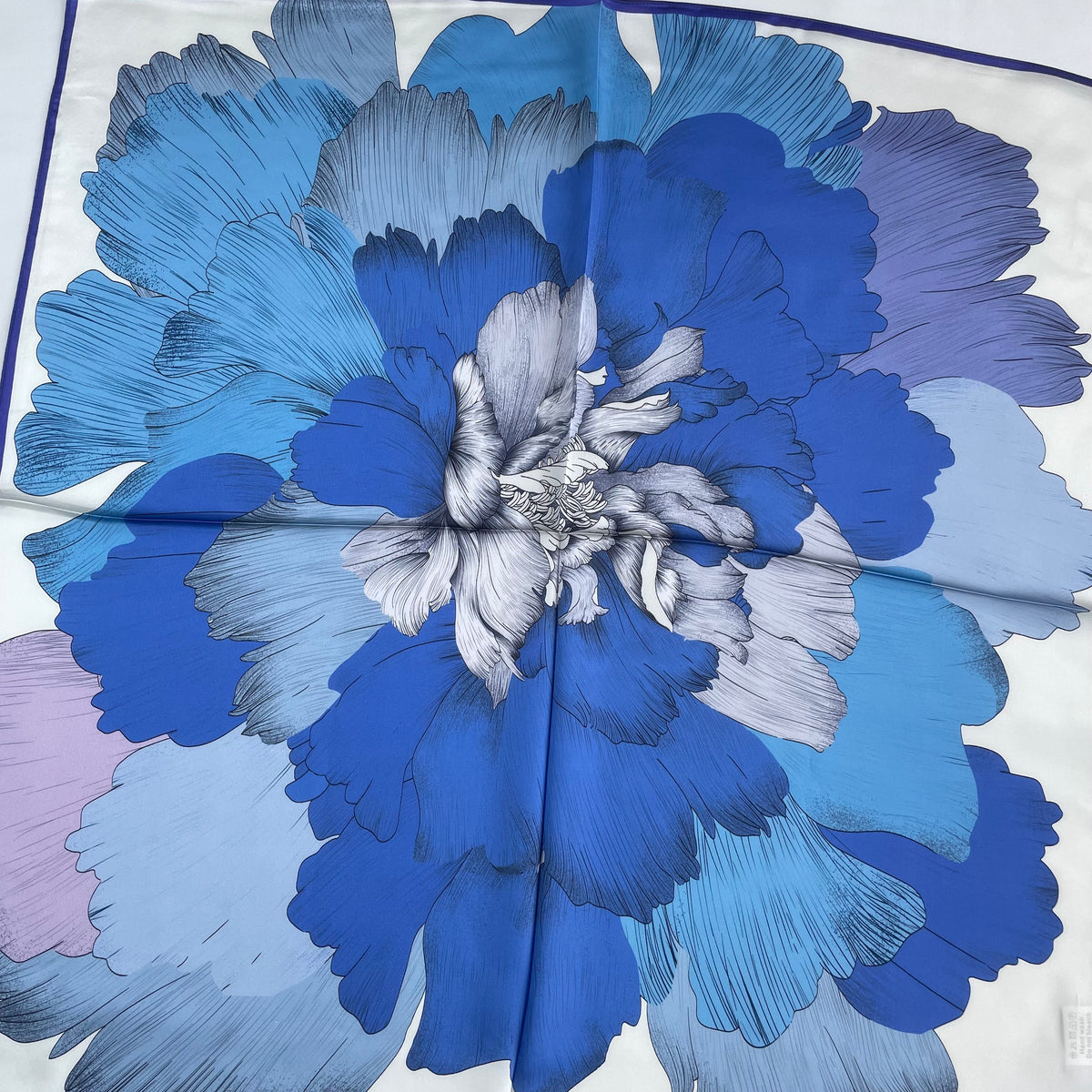 Close-up of the oversized blue and lilac flower on The Blue Flowers scarf